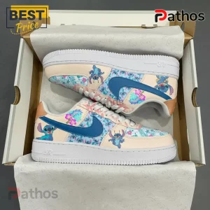 Custom Stitch shoes with tropical floral print in blue and pink! Cream sneakers with a blue swoosh and cartoon character design!