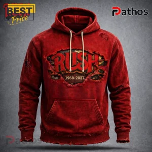 Red distressed hoodie with a ripped graphic of the Rush band logo and text reading 'RUSH 1968-2027' in a vintage rock style!