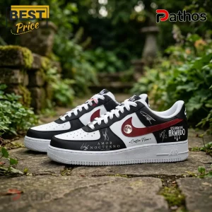 Custom black and white sneakers with red swoosh Eslabon Armado Amor Nocturno text and moon graphic on stone background!