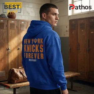 New York Knicks 2026 Playoffs Eastern Conference Finals Hoodie 2 Blue hoodie with orange text New York Knicks Forever and 2026 Playoffs logo worn in a locker room setting!