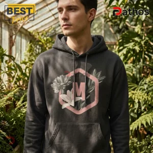 Dark grey hoodie featuring a pink hexagon frame with letter M and floral illustrations!
