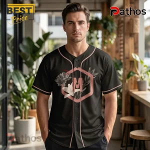 Black baseball jersey with pink trim, floral graphic design, and a letter M inside a hexagon.!
