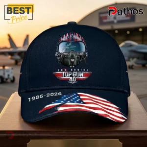 Top Gun 40th Anniversary Tom Cruise 1986-2026 Memorial Baseball Cap 1 Navy blue baseball cap with Top Gun 40th anniversary logo helmet graphic, US flag print, and 1986-2026 text.!