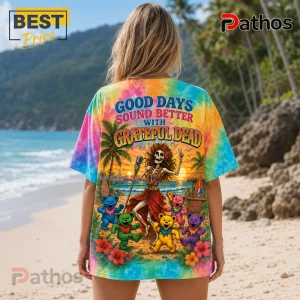 Grateful Dead Good Days Summer Tie Dye T-Shirt 4 Tie-dye t-shirt featuring a skeleton in a grass skirt, colorful dancing bears, and text Good Days Sound Better With Grateful Dead.!