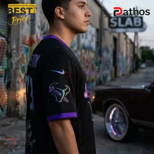 Man wearing a black mesh jersey with purple trim and iridescent graphics including a logo on the sleeve and back number 73.!