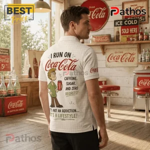 Man wearing a white polo shirt with Shaggy from Scooby-Doo holding a Coca-Cola can and text about caffeine and lifestyle.!