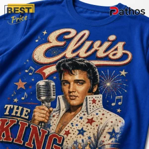 Blue cotton t-shirt featuring a vintage graphic of Elvis Presley with a microphone, firework icons, and text The King.!