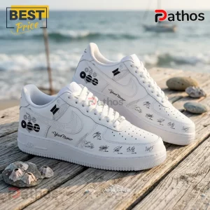 Custom white sneakers featuring BTS member signatures, black geometric logo, and Your Name text on a wooden beach pier.!