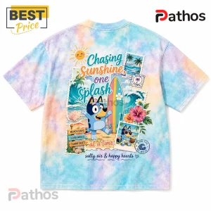 Bluey tie-dye t-shirt featuring beach illustrations, a surfboard, hibiscus flowers, and text reading Chasing Sunshine.!
