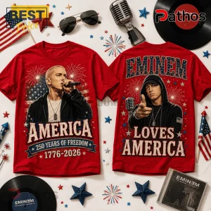 Red cotton T-shirt featuring Eminem, American flag graphics, fireworks, and text reading America 1776-2026 and Loves America.!