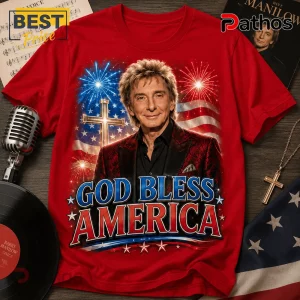 Red cotton t-shirt featuring Barry Manilow, American flag background, cross icon, fireworks, and text God Bless America.!