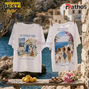 Two white cotton t-shirts hanging on a clothesline featuring Mamma Mia movie-inspired prints of Greece and coastal life.!