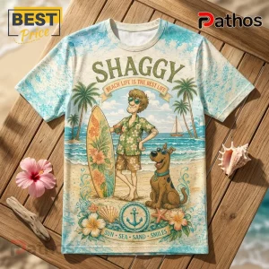 Scooby-Doo Shaggy Funny Sunglasses T-Shirt 2 Scooby-Doo and Shaggy graphic print t-shirt featuring surfboard, palm trees, and ocean motif on a light blue background.!