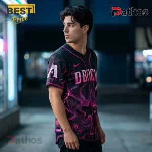 Man wearing black and pink Arizona Diamondbacks baseball jersey with lightning patterns and D-Backs lettering at night.!