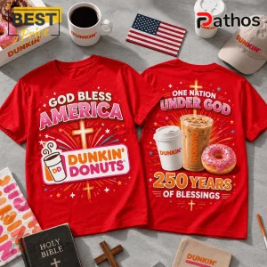 Red cotton t-shirts displaying Dunkin Donuts graphics, crosses, and patriotic text on a table with coffee and donuts.!