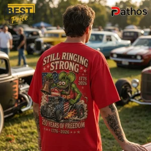 Red cotton t-shirt featuring a green monster driving a classic hot rod, American flag, and 1776-2026 freedom graphics.!