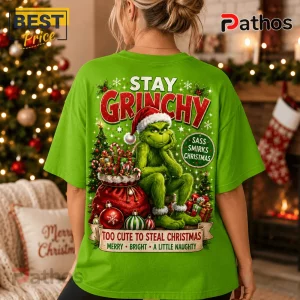 Bright green t-shirt with Grinch graphic, Santa hat, gifts, and text Stay Grinchy, Too Cute To Steal Christmas.!