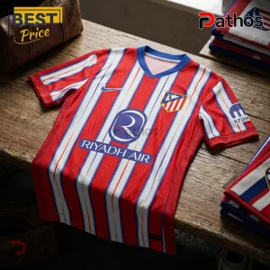 Atletico Madrid jersey featuring red and white vertical stripes, Riyadh Air branding, Nike logo, and blue collar.!