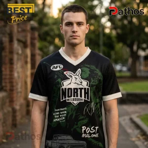 North Melbourne x Post Malone Big Ass World Tour 2026 Football Jersey 1 Man wearing black North Melbourne AFL jersey with kangaroo graphic, Post Malone text, and truck illustration on shirt.!