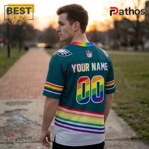 Man wearing a green Philadelphia Eagles football jersey with custom pride rainbow name, number 00, and sleeve stripes.!