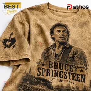 Bruce Springsteen Rock and Roll Never Forgets Timeless T-Shirt 4 Bruce Springsteen graphic t-shirt with beige vintage-wash texture, concert print, and guitar heart icon on sleeve.!