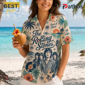 Woman wearing a beige button-up shirt with a The Rolling Stones graphic, palm trees, hibiscus flowers, and ocean scene.!