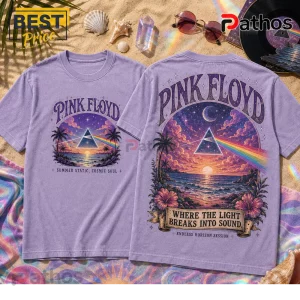 Lavender t-shirts with Pink Floyd prism art, beach sunset, palm trees, and text on a sandy background with seashells.!