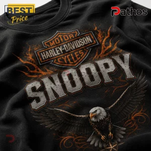 Black cotton t-shirt featuring a Harley-Davidson logo, Snoopy text in metallic font, and a flying bald eagle illustration.!