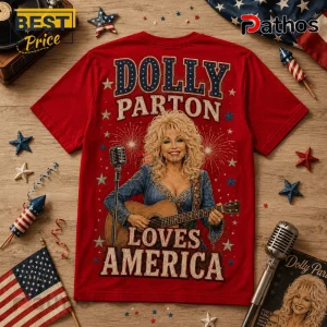 Dolly Parton x USA 250 Years of Freedom Anniversary T-Shirt 3 Red graphic t-shirt featuring Dolly Parton playing guitar with Dolly Parton Loves America text and firework designs.!
