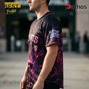 Man wearing black and pink baseball jersey featuring K-Pop Demon Hunters graphic and San Francisco Giants team branding.!