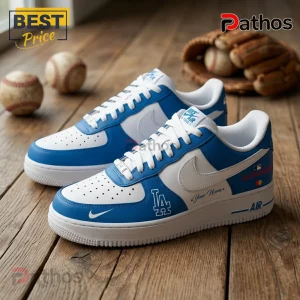 Los Angeles Dodgers custom blue and white sneakers with LA logo on wood floor next to baseballs and a leather glove.!