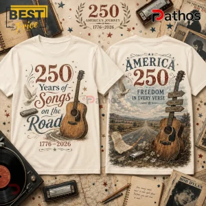 USA 250th Anniversary Heritage Guitar Off-White T-Shirt 1 Two cream-colored t-shirts featuring vintage acoustic guitars, harmonicas, and Americana typography celebrating 250 years.!
