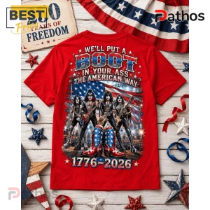 Red graphic t-shirt featuring KISS band members, American flag background, patriotic cowboy boots, and 1776-2026 text.!