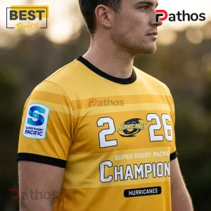Man wearing yellow and black Hurricanes rugby jersey featuring 2026 Super Rugby Pacific Champion text and team logos.!