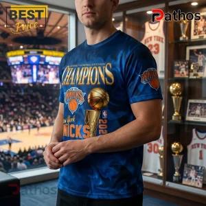 Man wearing blue New York Knicks NBA champions graphic t-shirt featuring golden basketball trophy and team logos.!