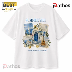 White graphic t-shirt featuring a Mediterranean travel collage with lemons, a sailboat, a blue door, and a guitar.!
