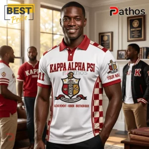 Man wearing a white and red Kappa Alpha Psi polo shirt featuring fraternity crest, checkered side panels, and text.!