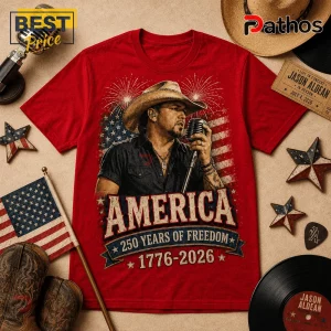 Jason Aldean America 250 Years 1776-2026 Patriotic Concert T-Shirt 2 Red cotton t-shirt featuring Jason Aldean wearing a cowboy hat, singing into a microphone with US flag and firework art.!
