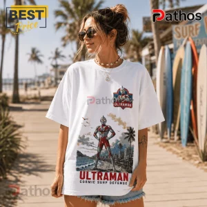 Woman wears white cotton t-shirt with Ultraman character graphic, vintage beach illustration, and Japanese text logo.!
