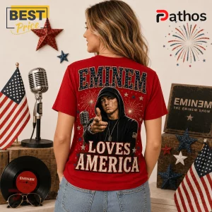 Red graphic t-shirt featuring Eminem in a black hoodie pointing forward with text reading EMINEM LOVES AMERICA.!