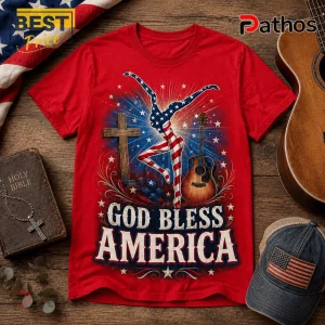Red cotton t-shirt featuring American flag pattern dancer, wooden cross, acoustic guitar, and text God Bless America.!