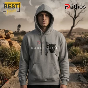 Man wearing a grey cotton hoodie with a black printed beetle graphic and the text Karnivool The Cata on the chest.!