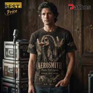 Aerosmith Band American Rock Legends Premium T-Shirt 3 Man wearing black Aerosmith band t-shirt with graphic print of Steven Tyler, stage lights, and text on wooden background.!