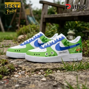 Custom white, green, and blue leather sneakers featuring Tay Story 5 branding, cartoon frog face, and personalized text.!