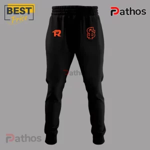Black cotton jogger pants with orange Pathos and SG logos on the thighs against a gray background.!