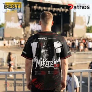Man wearing black baseball jersey with Mekenzie 2.0 Tour graphic, red trim, and concert background.!