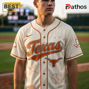 Cream and burnt orange Texas Longhorns baseball jersey featuring pinstripes, team logo, and baseball icons on a field.!
