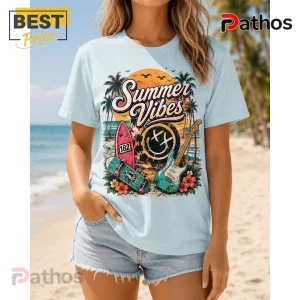 Blink-182 All Summer Long Pop Punk Graphic T-Shirt 4 Light blue t-shirt with Summer Vibes graphic featuring a surfboard, skateboard, electric guitar, and beach sunset scene.!