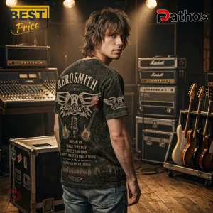 Aerosmith Band American Rock Legends Premium T-Shirt 2 Man wearing black Aerosmith graphic t-shirt featuring wings, guitars, and song titles in a recording studio setting.!