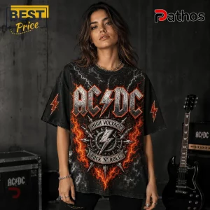 ACDC High Voltage Rock N Roll Band Black T-Shirt 3 Woman wearing black AC/DC band t-shirt with orange lightning bolt graphic and High Voltage text against dark background.!